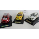 A Mitsubishi WRC Evo 7 in Ralli Art livery and a Mitsubishi Evo 7 in Scalextric livery,