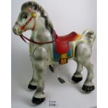 A vintage Mobo Bronco child's hobby horse, painted tin plate.