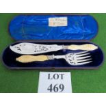 A pair of silver fish servers in original box, 32cm long, handles possibly ivory.