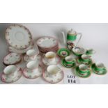 A part tea service with six cups and saucers decorated with floral sprays on a white ground,