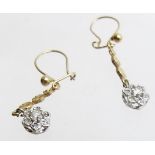 A pair of diamond flower design drop earrings.