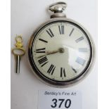 A silver pair cased pocket watch in working order with key.