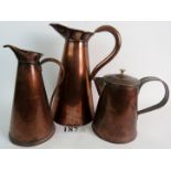 Three vintage copper jugs, one with lid, one marked `J S & S', from 27cm to 33cm high.
