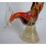 A Murano glass bird in the full rainbow of colours on a barley twist socle with gilt glass inset,