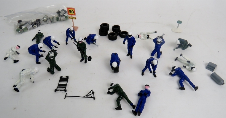 Various Scalextric pit crews and pit accessories, green, white and blue, oil drums, tyres etc.
