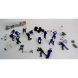 Various Scalextric pit crews and pit accessories, green, white and blue, oil drums, tyres etc.