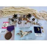 A Scottish grouse claw broach, a Disney silver charm, various enamel pins, other charms,