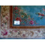 A mid 20's Chinese green rug, with a key border and flowers. 290cm x 185cm.