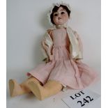 A Schoenau & Hoffmeister porcelain doll with the S SB H and star mark to the nape of the neck plus