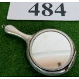 A silver mirror, with concealed compact compartment behind the glass, 19.5 grams.