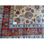 A superb quality carpet on cream ground with terracotta borders. 347cm x 253cm.