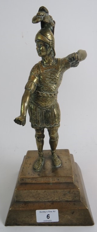 A heavy bronze figure of a Roman Centurion, on stepped plinth base, 34cm high.