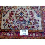 A late 20th century gallery rug with autumnal floral motifs on a beige field,