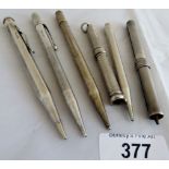 5 silver early 20th Century propelling or slide pencils 4 hallmarked,