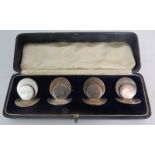 Four silver place holders hallmarked Chester 1907, in an Art Deco style, weight 105 grams,