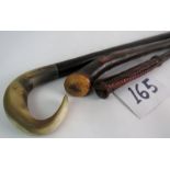 A leather riding crop - a naturalistic walking stick (probably briar wood) and a horn handled