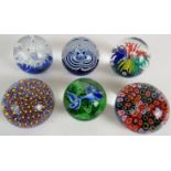 Six good decorative 20th century glass paperweights.