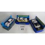 Three Group 4 era Scalextric cars, a Ford RS200, an Audi Sport Quattro and a Peugeot T16.
