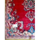 A mid 20th century Persian rug on claret ground, 180cm x 140cm approx.