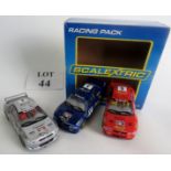 A Scalextric racing pack, containing a Subaru Impreza WRC in silver, one in blue and a third in red.
