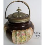 A Doulton Burslem biscuit jar in chocolate, with gilt decoration and ivory panels,
