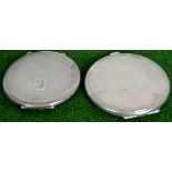 A pair of silver compacts, 72mm and 70mm.