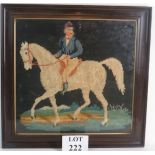 A vintage wool work panel depicting a jockey on horseback, inset grained frame.