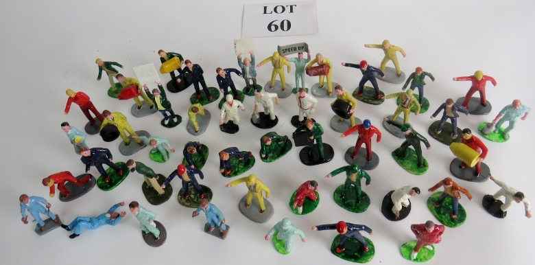 A collection of vintage figures, some pit crew, lane board holders etc.