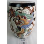 A Chinese ceramic barrel shaped garden seat with pierced decoration of a dragon amongst clouds,