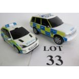 A Hornby Ford Focus WRC badged up as a Police Car and a Range Rover in a similar livery.