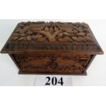 An Anglo Indian carved wood cigarette box in the Arts & Crafts taste,