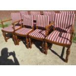 A set of eight good quality early 20th Century oak framed dining chairs with loose striped cotton