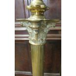 A 19th Century brass standard lamp modelled as a corinthium column with square base and lion paw