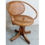 A 20th Century Thonet style bentwood swivel desk chair with bergere back and seat,