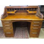 A large mahogany 'S' type roll top desk with fitted compartments to interior over eight drawers to