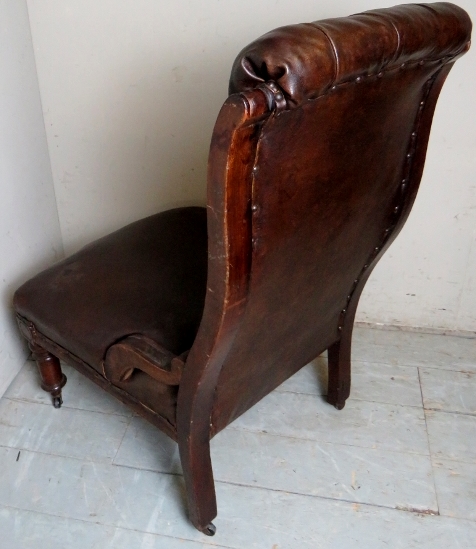A Victorian mahogany framed library chair upholstered in button backed brown leather and - Image 4 of 5