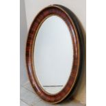 A large 19th Century oval wall mirror with bevelled edge glass and gilt border.