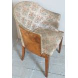 A 20th Century Art Deco style tub chair with walnut veneered sides and upholstered in a floral