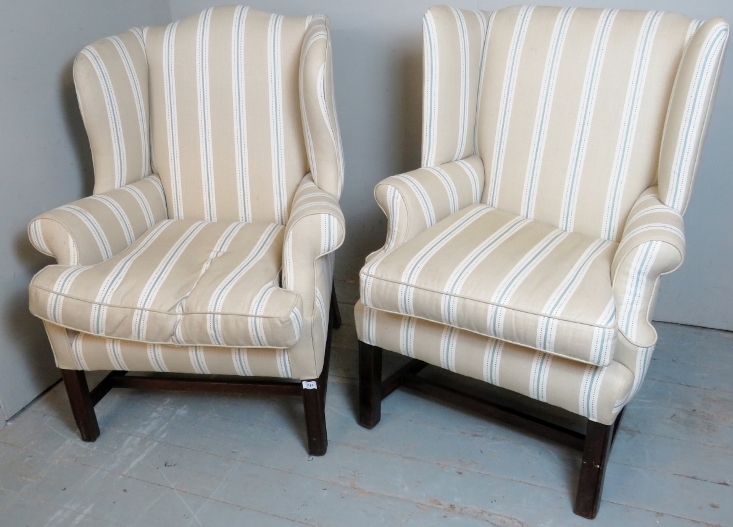 Two Georgian style mahogany framed wing back armchairs,