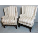 Two Georgian style mahogany framed wing back armchairs,