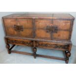 A large Spanish colonial style sideboard with two cupboards over two long drawers,