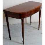 A 19th Century mahogany demi-lune turnover tea table terminating on turned legs.