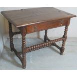 An 18th Century country oak hall / side table with a single long drawer beneath a planked top over