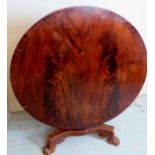 A 19th Century mahogany tilt top breakfast table with a flame mahogany top over a carved column and