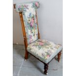 A late Victorian show wood prie dieu prayer chair upholstered in a floral material with turned