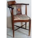 An Edwardian mahogany corner chair with boxwood stringing and inlaid shell pattern over tapered