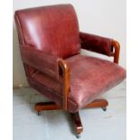 A 20th Century mahogany framed Gainsborough style swivel office desk chair upholstered in a brown