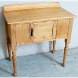 A Victorian pine low cabinet with a raised gallery rail to back over a central cupboard door and