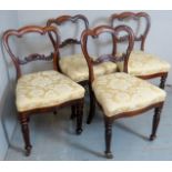 A set of four 19th Century rosewood dining chairs with cream and gold upholstery over carved legs