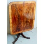 A William IV rectangular tilt top table with a rosewood banded and flame mahogany top over a turned